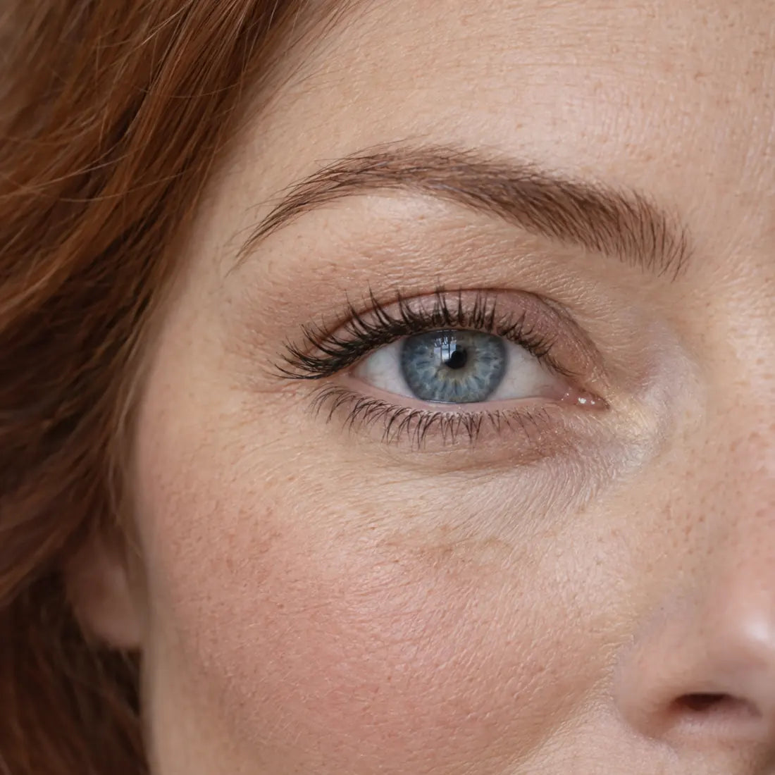 Close-up of a woman with softly framed brows and separated, defined lashes