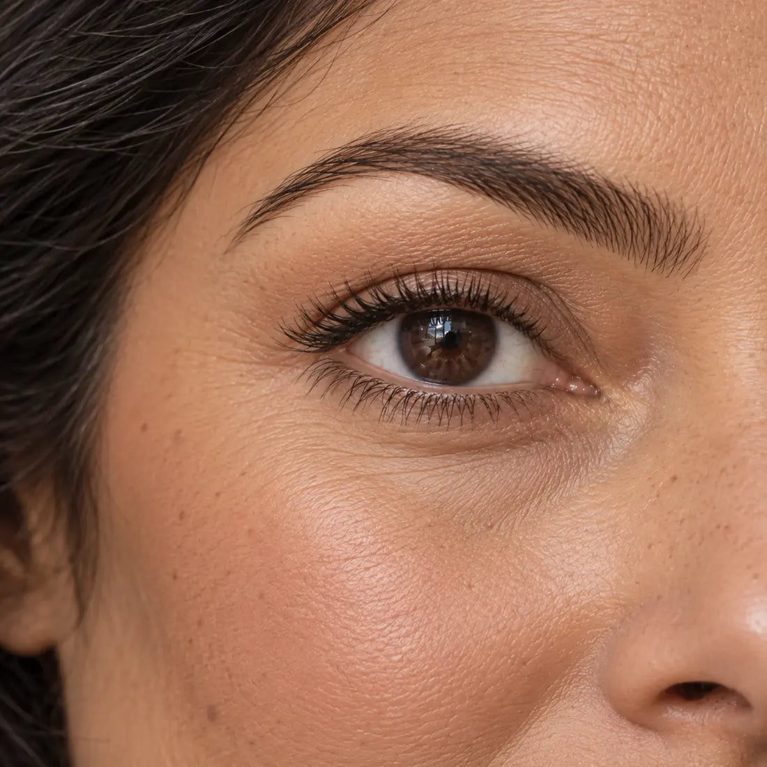Close-up of a woman with softly framed brows and separated, defined lashes