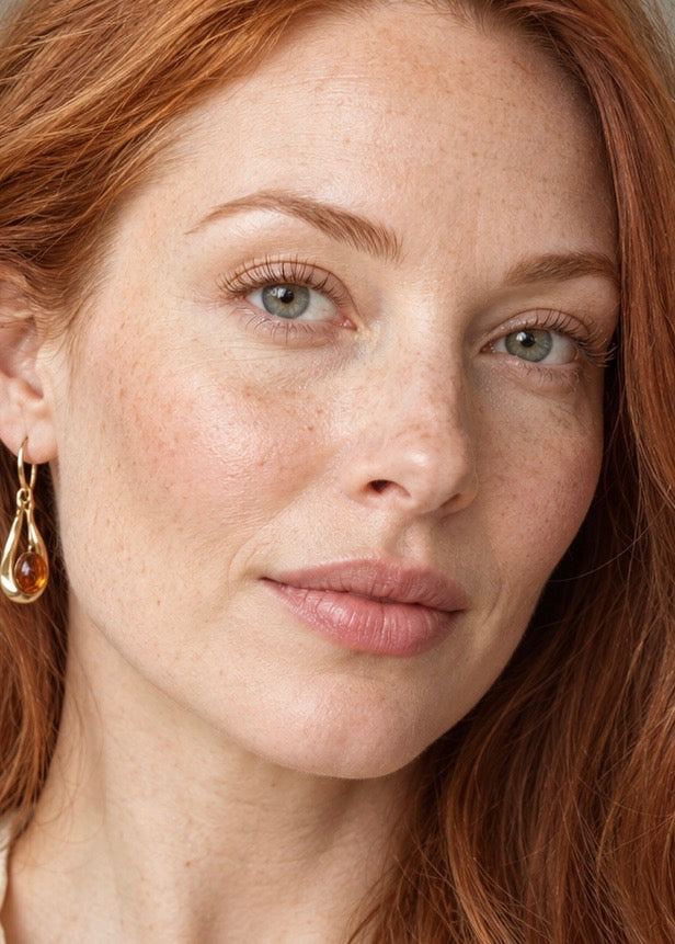 Close-up of the redheaded model showing her softly curled, separated bare lashes